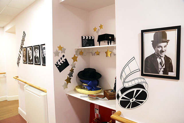 A Hollywood themed corridor with clapper boards and blachk and white photographs of actors portraits 